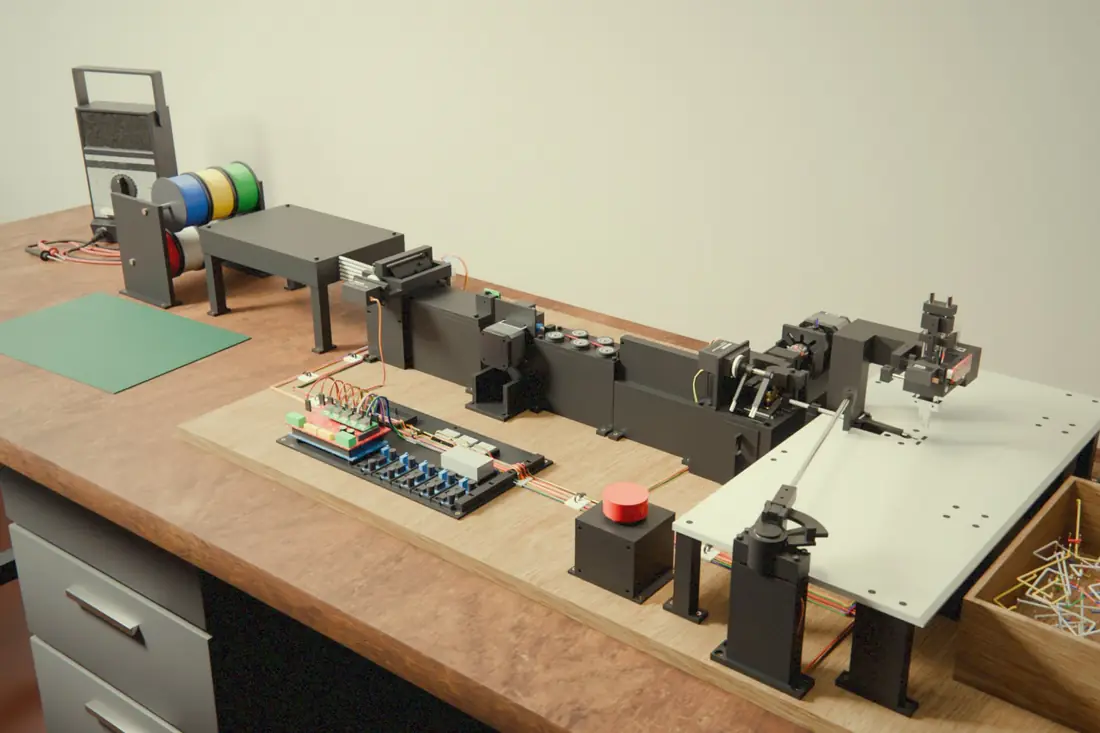 Render of the wire bender design on a workbench: wire spools, a feeder, a cutter and a bending head on a board, with a bin of bent jumper wires